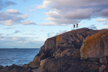 Father And Daughter Jumping On Rocks At Bullock Harbour, Dublin.