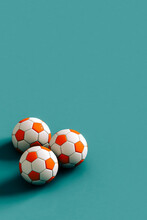 Three Soccer Balls Ona  Blue Background. 3d Render