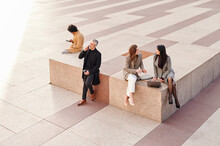 Businesspeople Sitting Outdoors During A Break