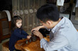 © Nicklaus Walter/Stocksy - Chinese Father And Multiracial Daughter Play While Drinking Tea.