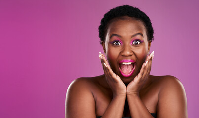 Poster - Theres a surprise on the way. Studio shot of a beautiful young woman looking surprised against a pink background.