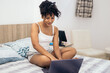 © Pedro Merino/Stocksy - Latin young woman with laptop at home
