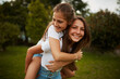 © Lyndon S/peopleimages.com - Im her biggest supporter. Cropped portrait of a young girl giving her younger sister a piggyback ride outdoors.