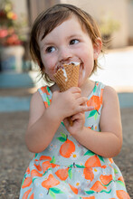 Happy Little Girl Eating Ice Cream With Dirty Face In Summer