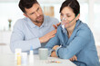 © auremar - husband comforting wife wearing oxygen mask at home