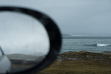 Blurred Car Mirror With The Sea In The Background