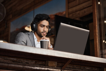 Poster - He can work from anywhere. Shot of a young businessman working in a cafe.
