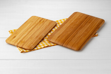 Wall Mural - Wooden cutting board on cotton napkin on white wooden table