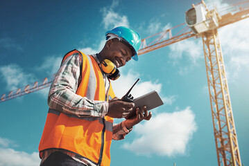 Poster - New age tech for new age construction. Shot of a young man using a digital tablet while working at a construction site.
