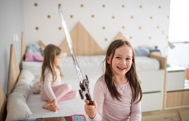 Cheerful little children in playing at home, looking at camera.