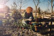 © cherryandbees - woman enjoying time in her backyard planting vegetables and herbs