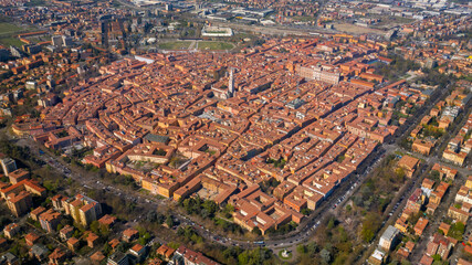 Wall Mural - Aerial view on the historic center of Modena surrounded by tree-lined avenues. In the center stands the Ghirlandina tower.