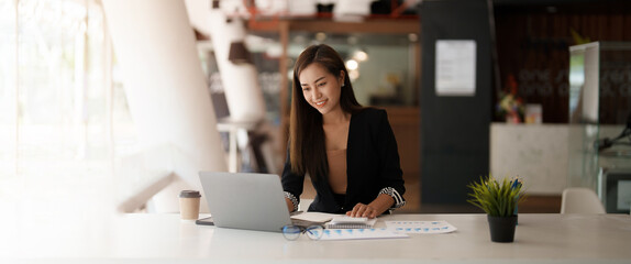 Wall Mural - Portrait asian business woman working on laptop computer and calculator for financial. business accounting concept