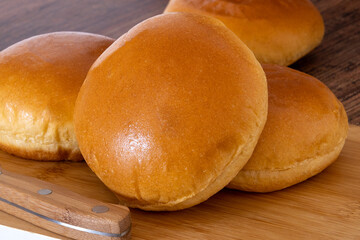 Fresh buns isolated on wooden background