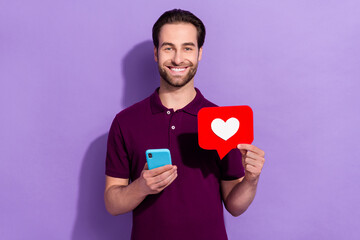 Wall Mural - Photo of funny positive young man influencer receive many likes on social media isolated on purple color background