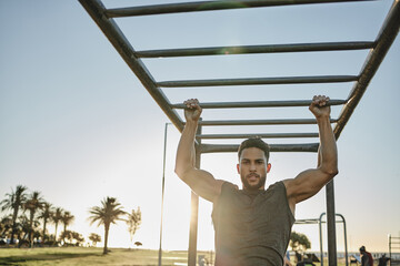 Poster - Youre watching a beast become more powerful. Portrait of a muscular young man exercising at a calisthenics park.