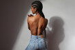 © face_reader_img - Back view portrait of African woman with long braids posing on grey background.