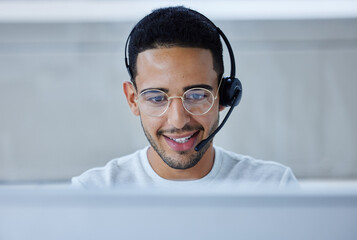Poster - Looking forward to taking the day by the horns. Shot of a young businessman working at his desk in his office.