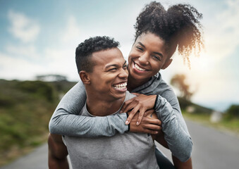 Canvas Print - Well get there...together. Cropped shot of a handsome young sportsman piggybacking his athletic young girlfriend outside.