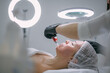 © Anna - Cosmetologist and dermatologist makes injections with a mesotherapy apparatus to a lying woman patient in a beauty salon.