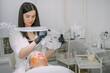 © Anna - Cosmetologist and dermatologist makes a moisturizing, rejuvenating woman lying patient in a beauty salon.