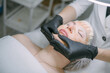 © Anna - Cosmetologist and dermatologist makes a moisturizing, rejuvenating woman lying patient in a beauty salon.