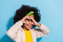 Portrait Of Attractive Funny Cheerful Girl Schoolkid Showing Heart Shape Look See Spy Isolated Over Bright Blue Color Background