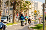 Fototapeta  - unknown people commuting by bike in the street of La Serena