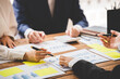 © Daenin - Teamwork with price chart analyzes business people on the table at the conference room.