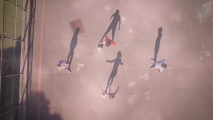 Wall Mural - Animation of light spots over diverse schoolchildren playing football