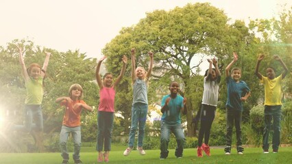 Poster - Animation of light spots over diverse schoolchildren jumping in park