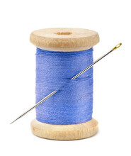Front View Of Wood Spool Of Blue Thread And Needle