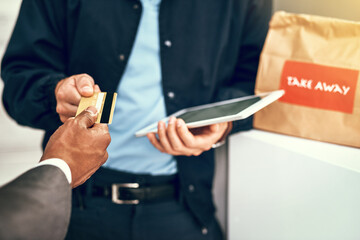 Poster - Its quick and convenient. Closeup shot of a businessman using a credit card to pay for a delivery made by a courier.