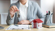 © snowing12 - Insurance concept the real estate representative giving a house key to his client after signing the contract