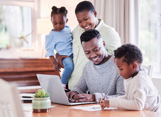 Poster - Family gives you the roots to stand tall and strong. Shot of a happy young family huddled together while looking at a laptop at home.