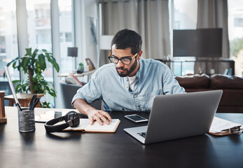 Poster - Im just as productive, if not more so, while working from home. Shot of a young man using his laptop while working from home.