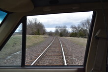 View Of Train Tracks From A Truck Window