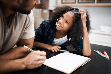 Wall Mural - Will break for dad jokes. Shot of a young girl doing a school assignment with her father at home.