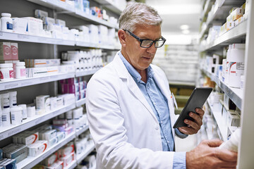 Aufkleber - i might actually take some of this later. shot of a focused mature male pharmacist making notes of t