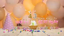 Beautiful Background Happy Birthday Number 43 With Burning Candles, Birthday Candles Pink Letters For Forty Three Years. Festive Background With Balloons