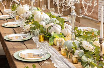 Autumn and Thanksgiving table decoration with white mini pumpkins.