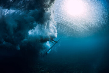  Surfer woman with surfboard dive underwater with under sea wave.