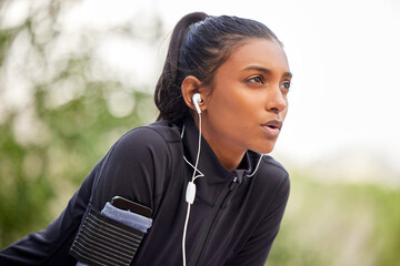 Canvas Print - Breathe through what you go through. Shot of a fit young woman catching her breathe while completing her jog outdoors.