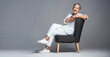 © Chanelle Malambo/peopleimages.com - Relax, youve earned it. Studio shot of a senior woman sitting on a chair against a grey background.
