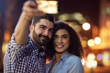 Poster - Memories are made of this. Shot of an affectionate young couple taking a selfie while out on a date in the city.
