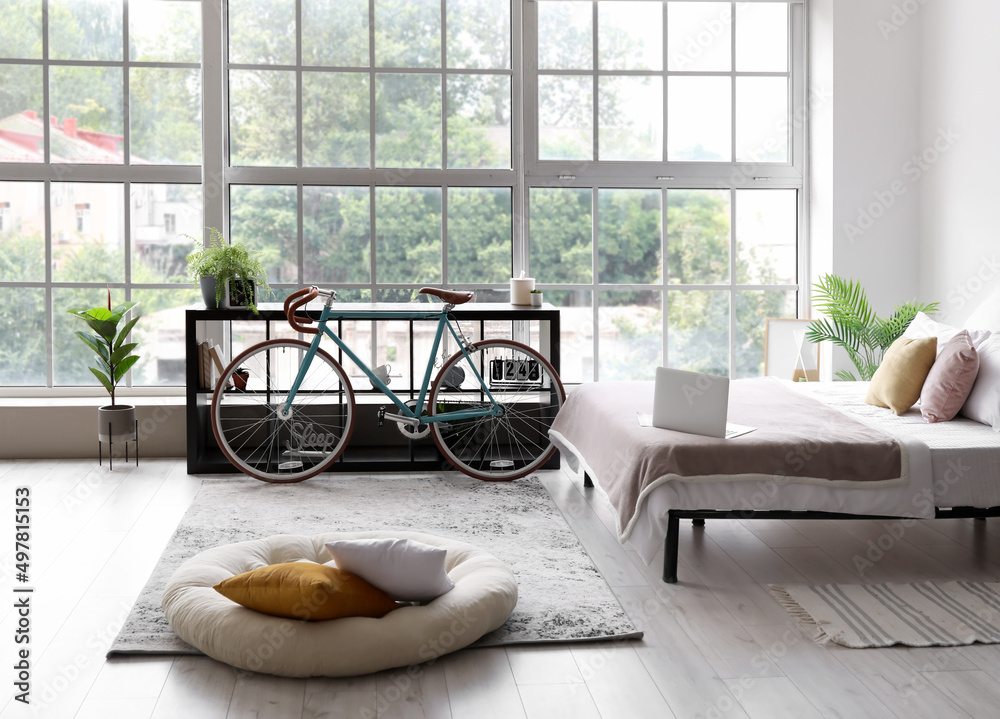 Interior of modern stylish bedroom with bicycle