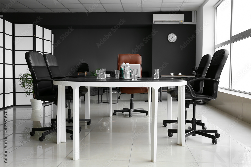 Large table and chairs in stylish conference hall interior