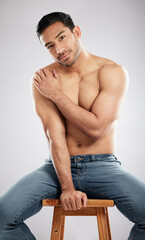 Poster - You create what you speak. Studio shot of a handsome young man showing off his muscular body while sitting on a chair against a grey background.