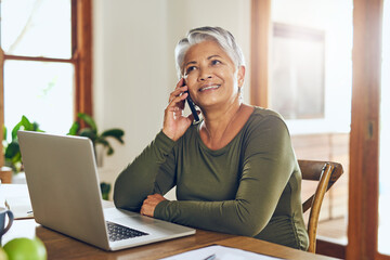 Poster - Her broker just called with some more good news. Shot of a mature woman talking on a cellphone while working on a laptop at home.