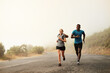 © Lyndon S/peopleimages.com - Sprint towards your goals. Shot of two sporty young people out for a run together.